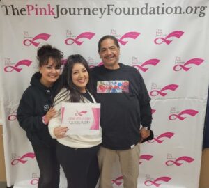 3 people in front of the pink journey background